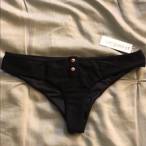 Frankie’s black bathing suit bottoms